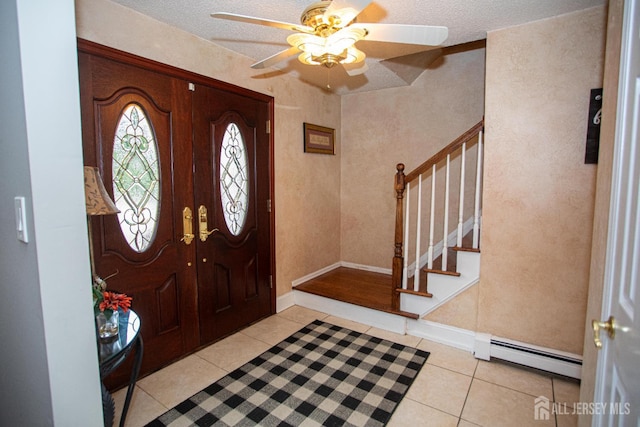 1 Stradford Rd, Sayreville, NJ 08859 - foyer featuring baseboard heating, stairs, light tile patterned floors, ceiling fan, and a textured ceiling