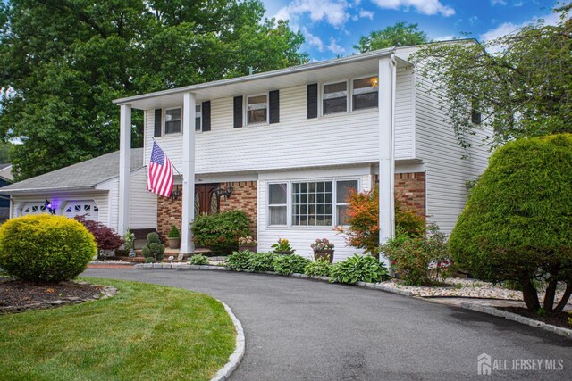 1 Stradford Rd, Sayreville, NJ 08859 - view of front facade with brick siding and a garage