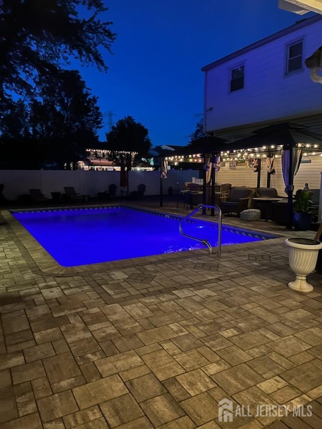 1 Stradford Rd, Sayreville, NJ 08859 - pool at night with a pergola, a patio area, a fenced backyard, and outdoor lounge area