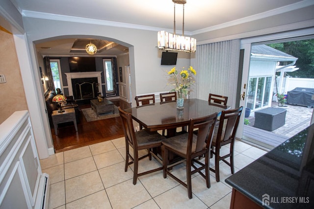 1 Stradford Rd, Sayreville, NJ 08859 - dining space featuring arched walkways, ornamental molding, baseboard heating, light tile patterned floors, and a fireplace