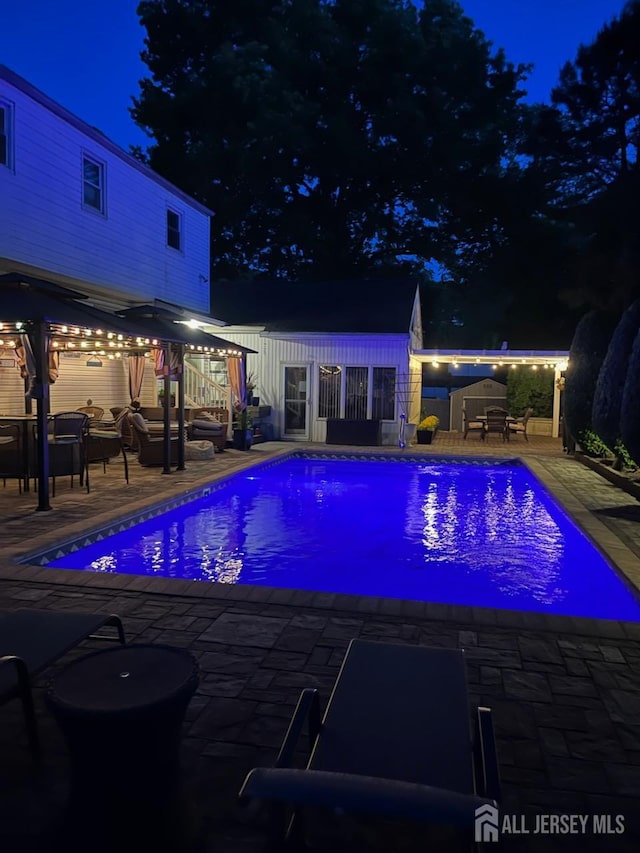 1 Stradford Rd, Sayreville, NJ 08859 - pool at twilight featuring a patio and an outdoor pool