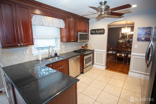 1 Stradford Rd, Sayreville, NJ 08859 - kitchen featuring appliances with stainless steel finishes, a chandelier, ceiling fan, backsplash, and a decorative wall