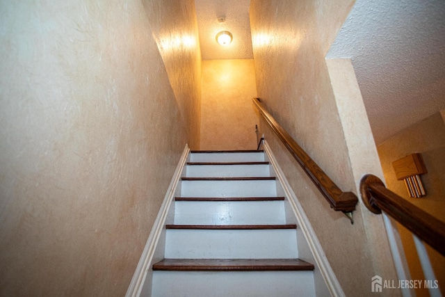 1 Stradford Rd, Sayreville, NJ 08859 - stairs featuring a textured wall and a textured ceiling