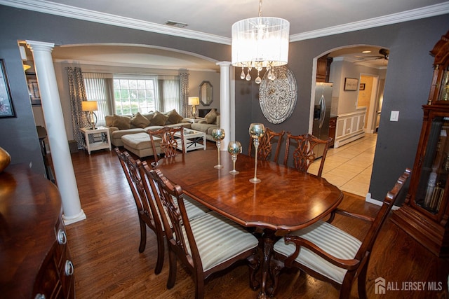 1 Stradford Rd, Sayreville, NJ 08859 - dining area with arched walkways, decorative columns, wood finished floors, and crown molding