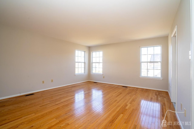 17 Larkspur Dr, South Brunswick, NJ 08810 - empty room featuring visible vents, baseboards, and light wood-style flooring
