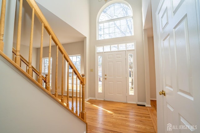 17 Larkspur Dr, South Brunswick, NJ 08810 - foyer entrance with light wood-style flooring, a high ceiling, baseboards, and stairs
