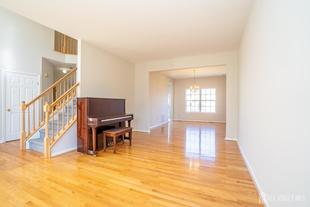 17 Larkspur Dr, South Brunswick, NJ 08810 - living area with light wood-type flooring, an inviting chandelier, baseboards, and stairway