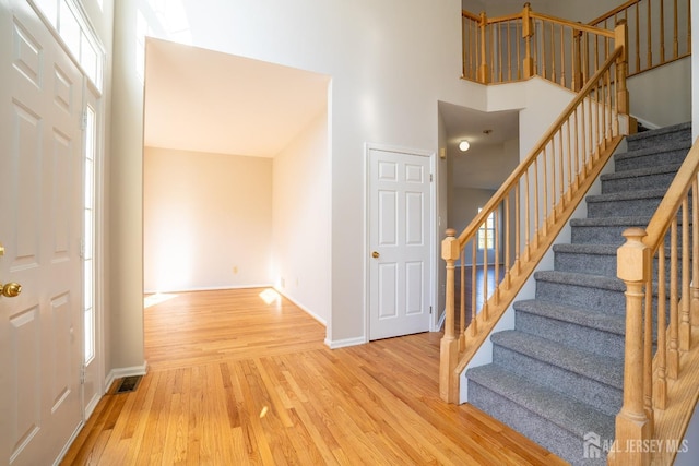 17 Larkspur Dr, South Brunswick, NJ 08810 - entrance foyer featuring baseboards, stairway, a high ceiling, and wood finished floors