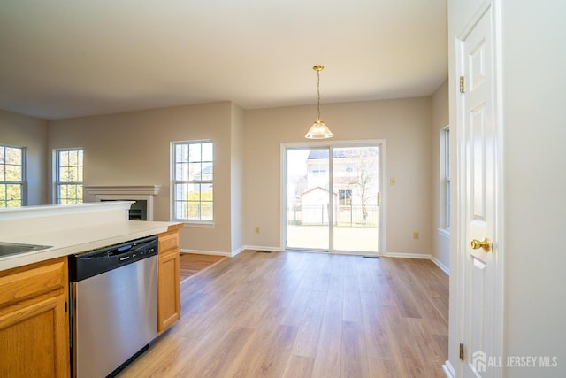 17 Larkspur Dr, South Brunswick, NJ 08810 - kitchen with stainless steel dishwasher, light wood finished floors, decorative light fixtures, and a healthy amount of sunlight