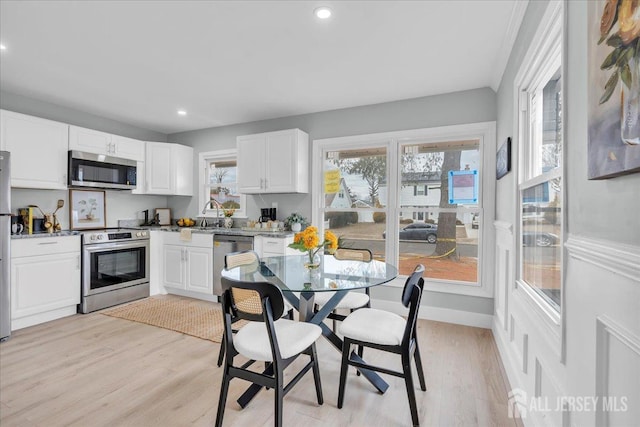 kitchen featuring light wood-style flooring, recessed lighting, appliances with stainless steel finishes, and white cabinetry