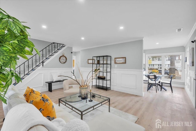 living room with recessed lighting, stairs, visible vents, ornamental molding, and wood finished floors