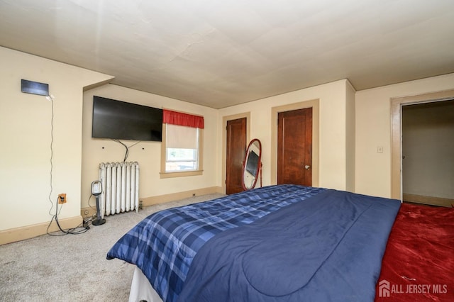 carpeted bedroom featuring radiator heating unit and baseboards