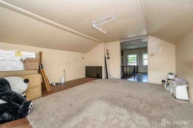 living room with baseboards, carpet, and lofted ceiling