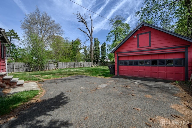detached garage featuring fence