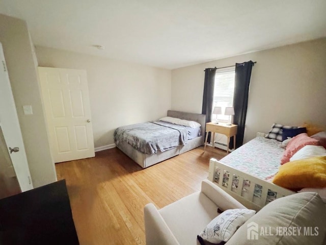 10 S 8th Ave S, Highland Park, NJ 08904 - bedroom featuring wood finished floors and a baseboard heating unit