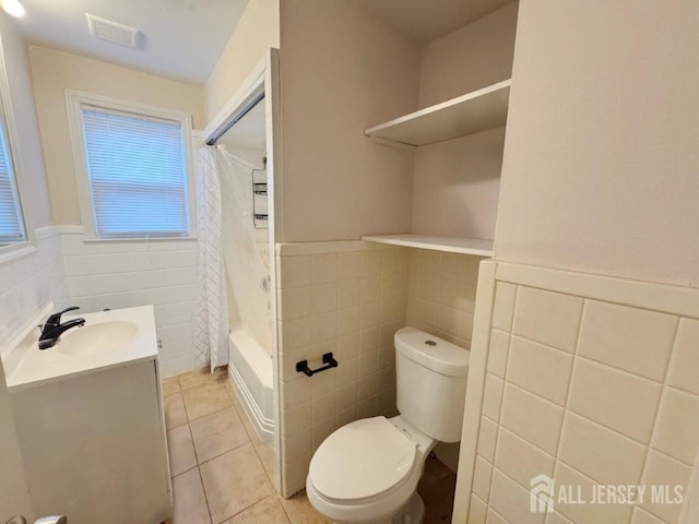 10 S 8th Ave S, Highland Park, NJ 08904 - full bathroom featuring tile walls, tile patterned floors, vanity, shower / tub combo with curtain, and wainscoting