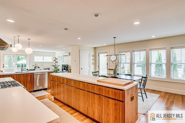 12 S 8th Ave, Highland Park, NJ 08904 - kitchen with dishwasher, brown cabinetry, light countertops, light wood-type flooring, and recessed lighting