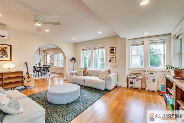 12 S 8th Ave, Highland Park, NJ 08904 - living room with arched walkways, wood finished floors, recessed lighting, a ceiling fan, and baseboards