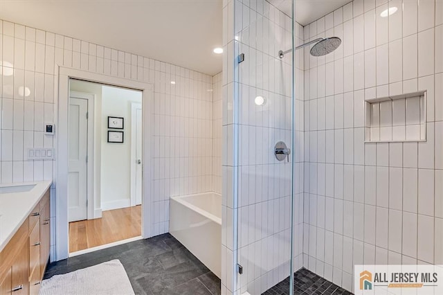 12 S 8th Ave, Highland Park, NJ 08904 - full bathroom featuring a stall shower, tile walls, vanity, a bath, and recessed lighting