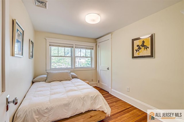 12 S 8th Ave, Highland Park, NJ 08904 - bedroom featuring wood finished floors and baseboards
