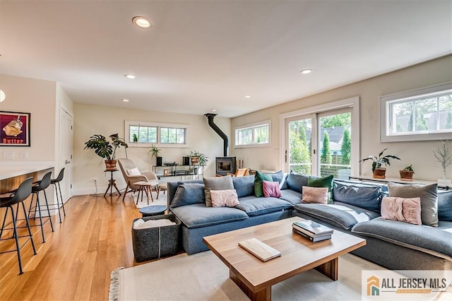 12 S 8th Ave, Highland Park, NJ 08904 - living room featuring a wood stove, recessed lighting, and light wood-type flooring