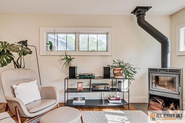 12 S 8th Ave, Highland Park, NJ 08904 - living area with a wood stove, baseboards, and wood finished floors