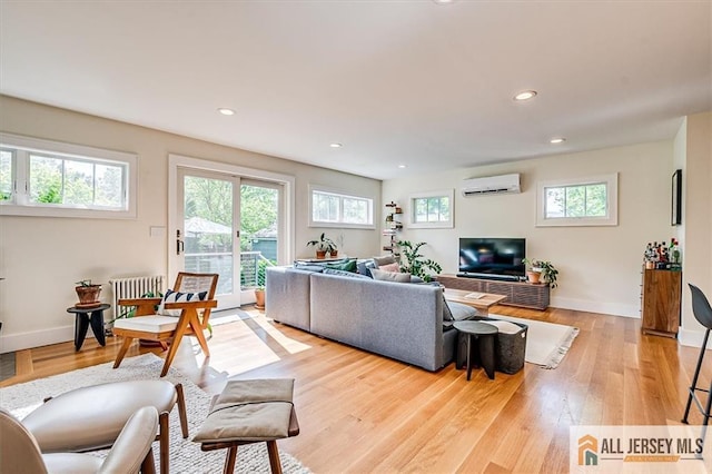 12 S 8th Ave, Highland Park, NJ 08904 - living room with a wall mounted air conditioner, plenty of natural light, light wood-type flooring, and recessed lighting