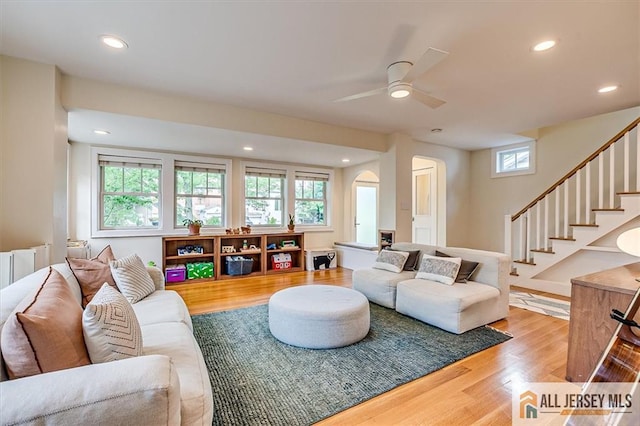 12 S 8th Ave, Highland Park, NJ 08904 - living room with arched walkways, light wood-style flooring, ceiling fan, recessed lighting, and stairs