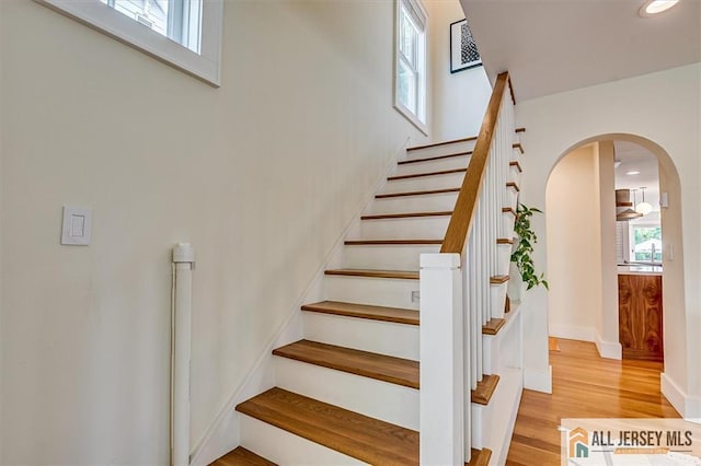 12 S 8th Ave, Highland Park, NJ 08904 - staircase featuring arched walkways, plenty of natural light, wood finished floors, baseboards, and recessed lighting
