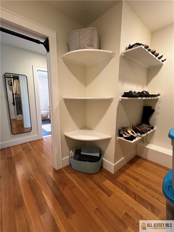 12 S 8th Ave, Highland Park, NJ 08904 - walk in closet featuring wood finished floors