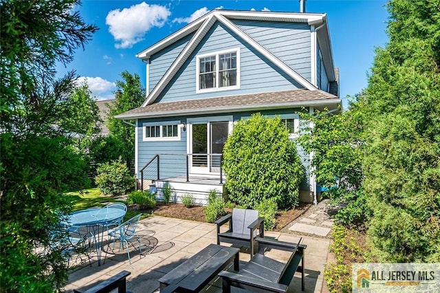 12 S 8th Ave, Highland Park, NJ 08904 - back of property with a patio area, outdoor dining space, and roof with shingles