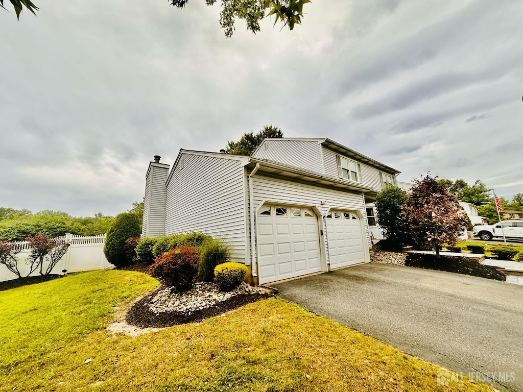 32 Wetherhill Way S, Brunswick, NJ 08810 - view of side of home featuring asphalt driveway and a chimney