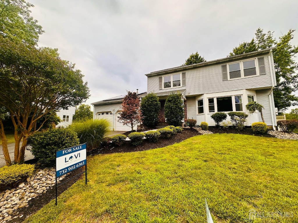 32 Wetherhill Way S, Brunswick, NJ 08810 - view of front facade featuring a garage and a front lawn