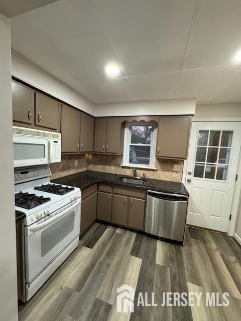 601 Ridgeway Ave, South Amboy, NJ 08879 - kitchen with white appliances, a sink, dark countertops, decorative backsplash, and dark wood-type flooring