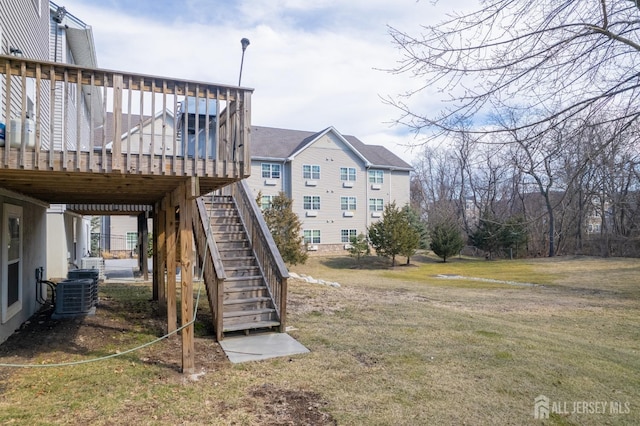 view of yard with central AC unit, stairway, and a wooden deck