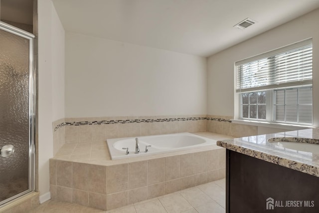 full bathroom featuring a stall shower, tile patterned flooring, visible vents, and a garden tub