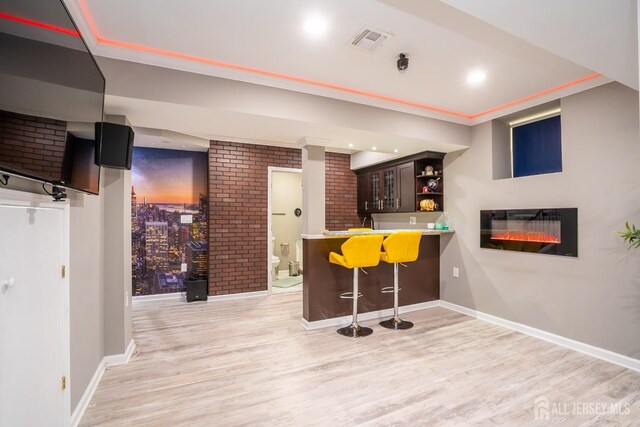 345 Morning Glory Dr, Monroe, NJ 08831 - indoor wet bar featuring light wood-style floors, baseboards, brick wall, and ornamental molding
