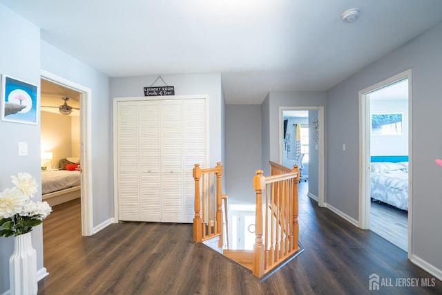 345 Morning Glory Dr, Monroe, NJ 08831 - corridor featuring dark wood-type flooring, baseboards, and an upstairs landing