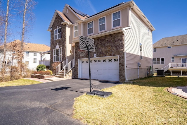 345 Morning Glory Dr, Monroe, NJ 08831 - traditional-style home featuring aphalt driveway, central AC, stone siding, a front yard, and a garage