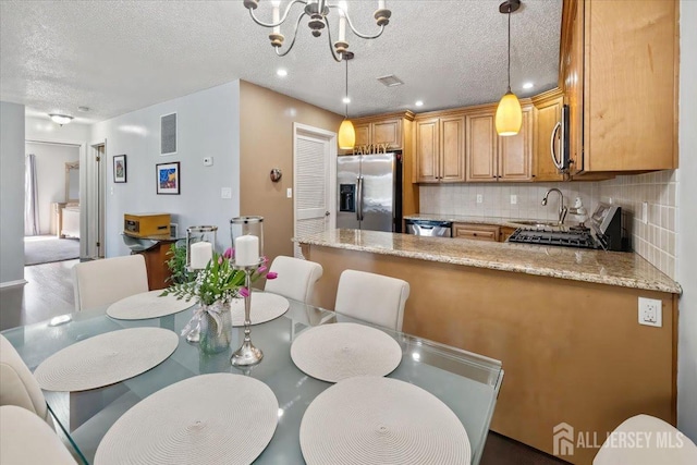 135 Hatfield Ln, East Brunswick, NJ 08816 - dining area with visible vents, an inviting chandelier, a textured ceiling, and recessed lighting