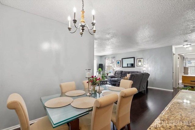135 Hatfield Ln, East Brunswick, NJ 08816 - dining room with a textured ceiling, a chandelier, dark wood-style flooring, and baseboards