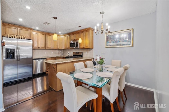 135 Hatfield Ln, East Brunswick, NJ 08816 - dining area with dark wood finished floors, baseboards, an inviting chandelier, and a textured ceiling