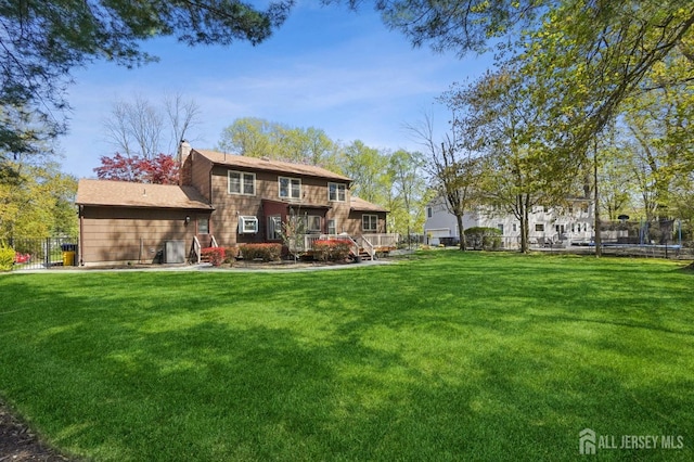 4 Franklin Ct, East Brunswick, NJ 08816 - rear view of house with a trampoline, a chimney, and a wooden deck