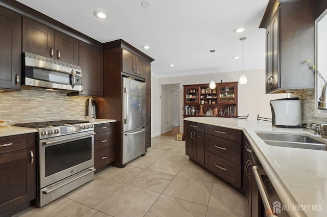 4 Franklin Ct, East Brunswick, NJ 08816 - kitchen with appliances with stainless steel finishes, light countertops, pendant lighting, dark brown cabinetry, and recessed lighting