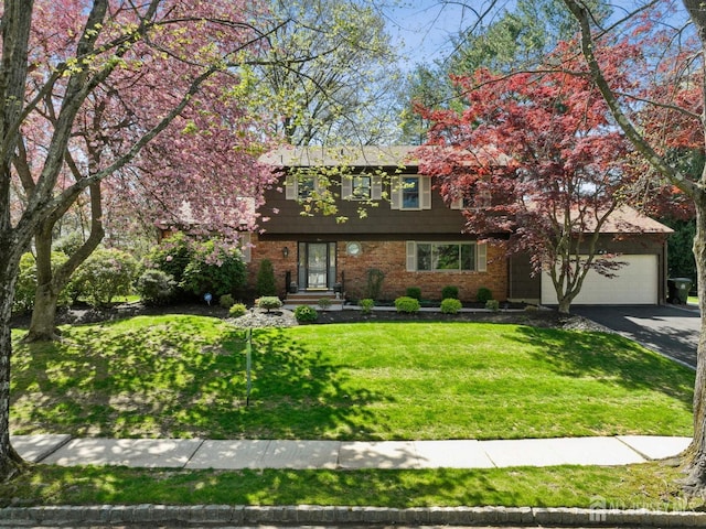 4 Franklin Ct, East Brunswick, NJ 08816 - colonial house with asphalt driveway, brick siding, an attached garage, and a front yard