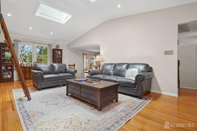 4 Franklin Ct, East Brunswick, NJ 08816 - living area featuring a skylight, lofted ceiling, ornamental molding, light wood finished floors, and baseboards