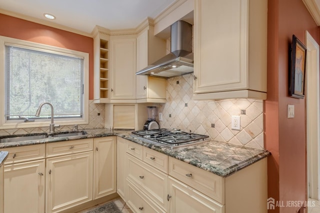 17 SE Candle Ln, East Brunswick, NJ 08816 - kitchen featuring stainless steel gas cooktop, a sink, dark stone counters, wall chimney exhaust hood, and cream cabinetry