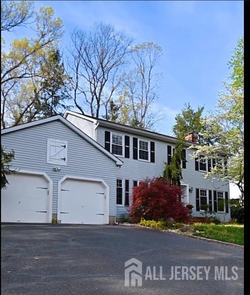 17 SE Candle Ln, East Brunswick, NJ 08816 - view of front of house with a garage and driveway
