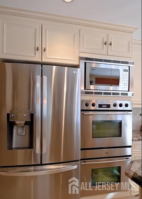 17 SE Candle Ln, East Brunswick, NJ 08816 - kitchen featuring stainless steel appliances and white cabinetry
