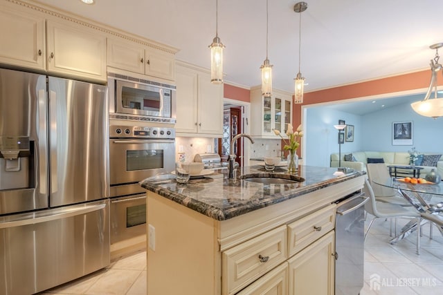 17 SE Candle Ln, East Brunswick, NJ 08816 - kitchen featuring cream cabinets, a sink, dark stone counters, stainless steel appliances, and light tile patterned floors